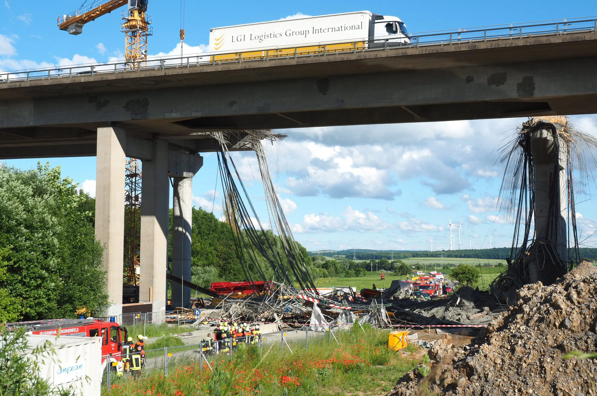 2016-06-15 00:00:00 epaselect epa05367311 A collapsed scaffolding lies under a highway bridge near Werneck, Germany, 15 June 2016. Several construction workers were killed in a scaffolding collapse at the construction site for a new highway bridge. People are still missing under the debris. EPA/NICOLAS ARMER