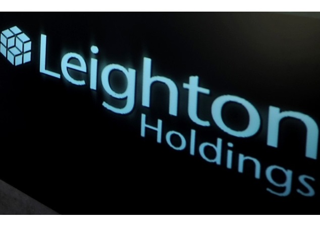 A woman passes by the Leighton Holdings Ltd. logo at the company's head office in Sydney, Australia, on Tuesday, Jan. 6, 2009. Leighton Holdings' first-half profit plunged 60 percent after Australia's largest engineering and construction company was forced to write down the value of its listed investments due to the global recession. Photographer: Jack Atley/Bloomberg News
