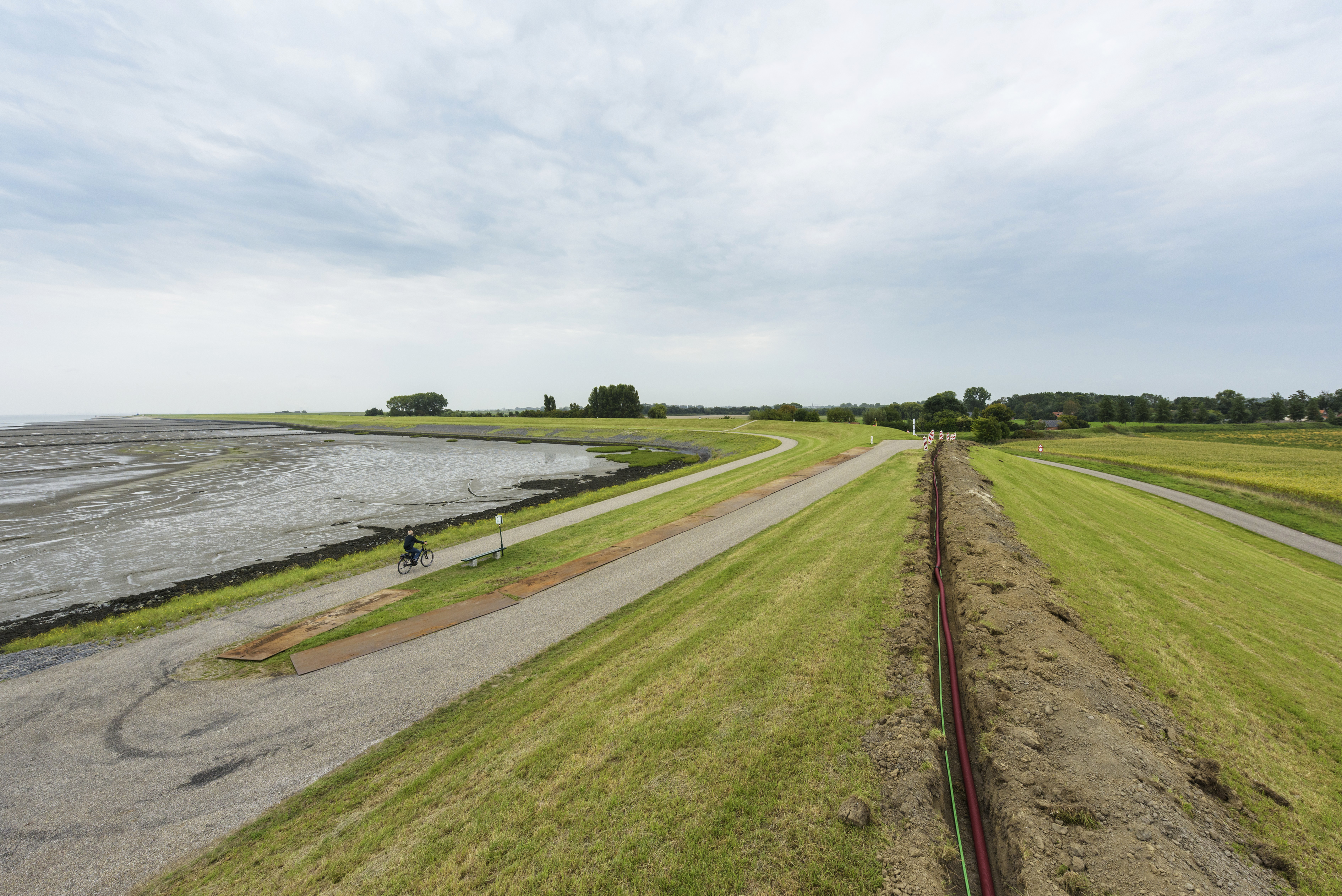 Kop van Ossenisse, Deltaplan Waterveiligheid, Hoogwaterbeschermingsprogramma, dijk langs de Westerschelde in Zeeuws Vlaanderen, landelijk gebied met akkerbouw, landbouw, eb en vloed, getijden, strandjes voor recreatie, fietspad buitendiks langs het water.
