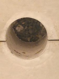Onderzoek Gebouw X: Als de kegel eruit is, zien de mannen een klein naadje tussen de breedplaat en de druklaag die erboven zit. Foute boel.