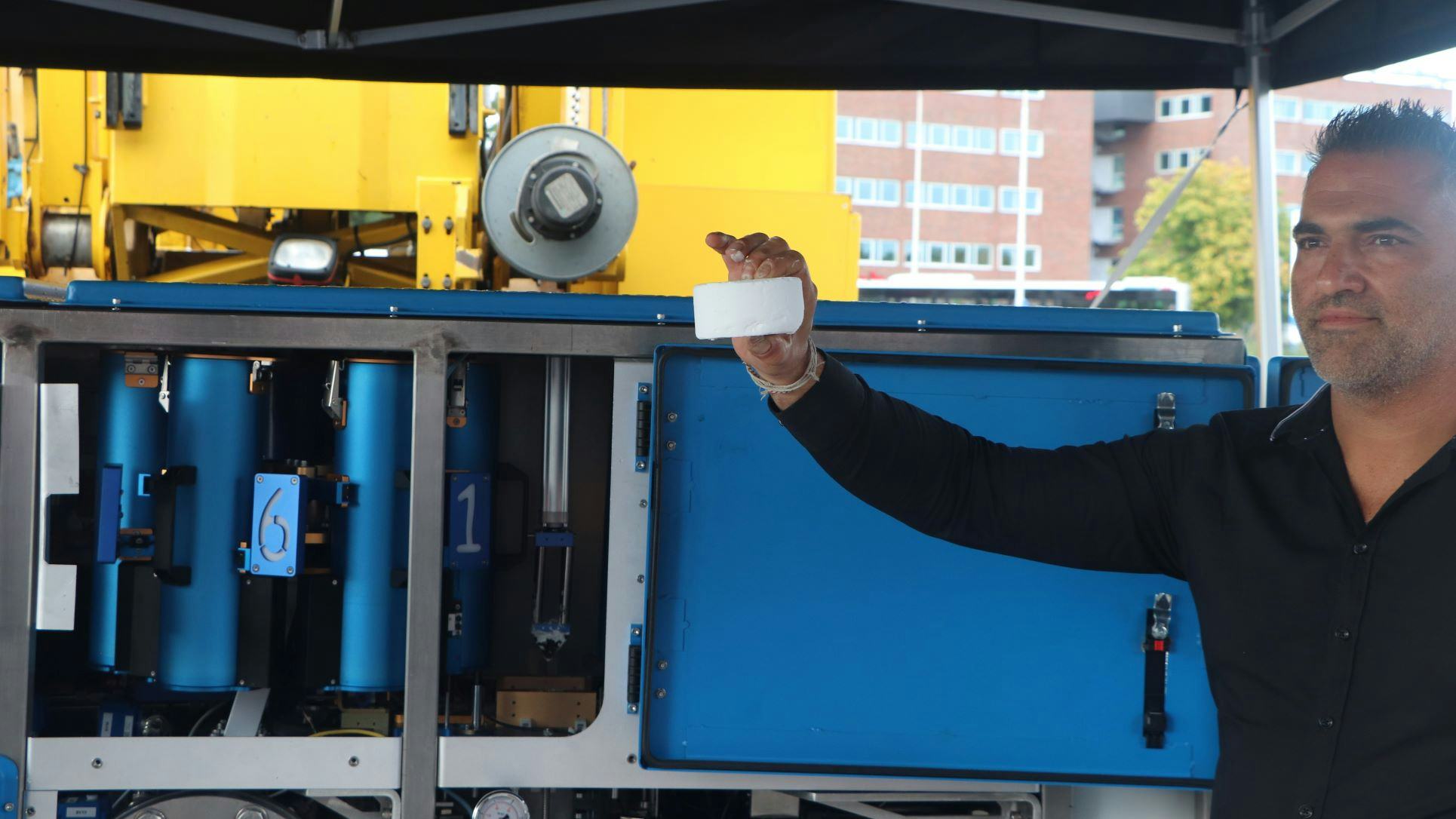 Een technical engineer van Electriq Global toont een tablet met waterstofpoeder. Foto: Henk Wind