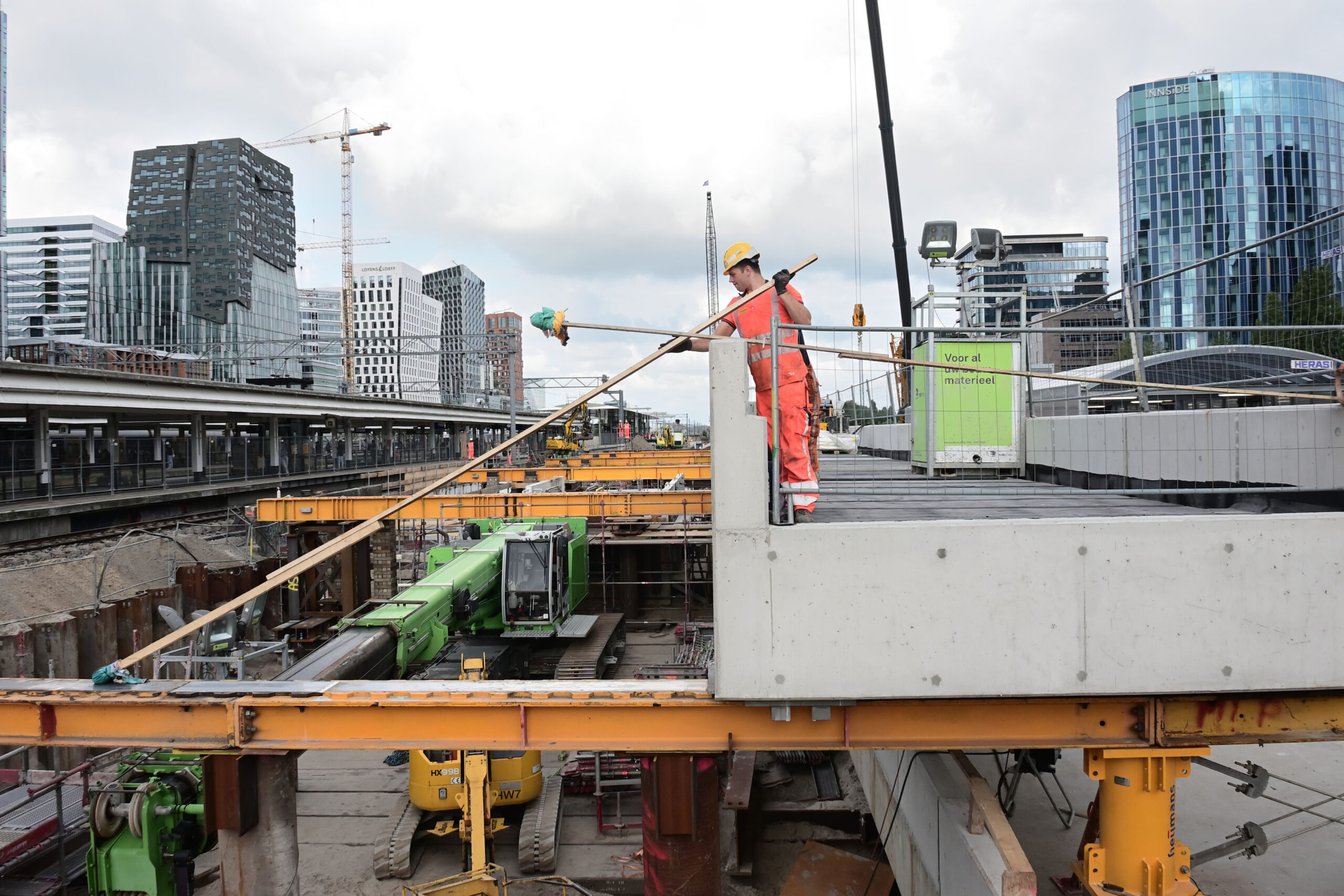 Een medewerkers van combinatie Nieuw-Zuid brengt smeermiddel aan op de baan, waarover het metrodek naar zijn plek glijdt. Foto: Ronald Bakker
