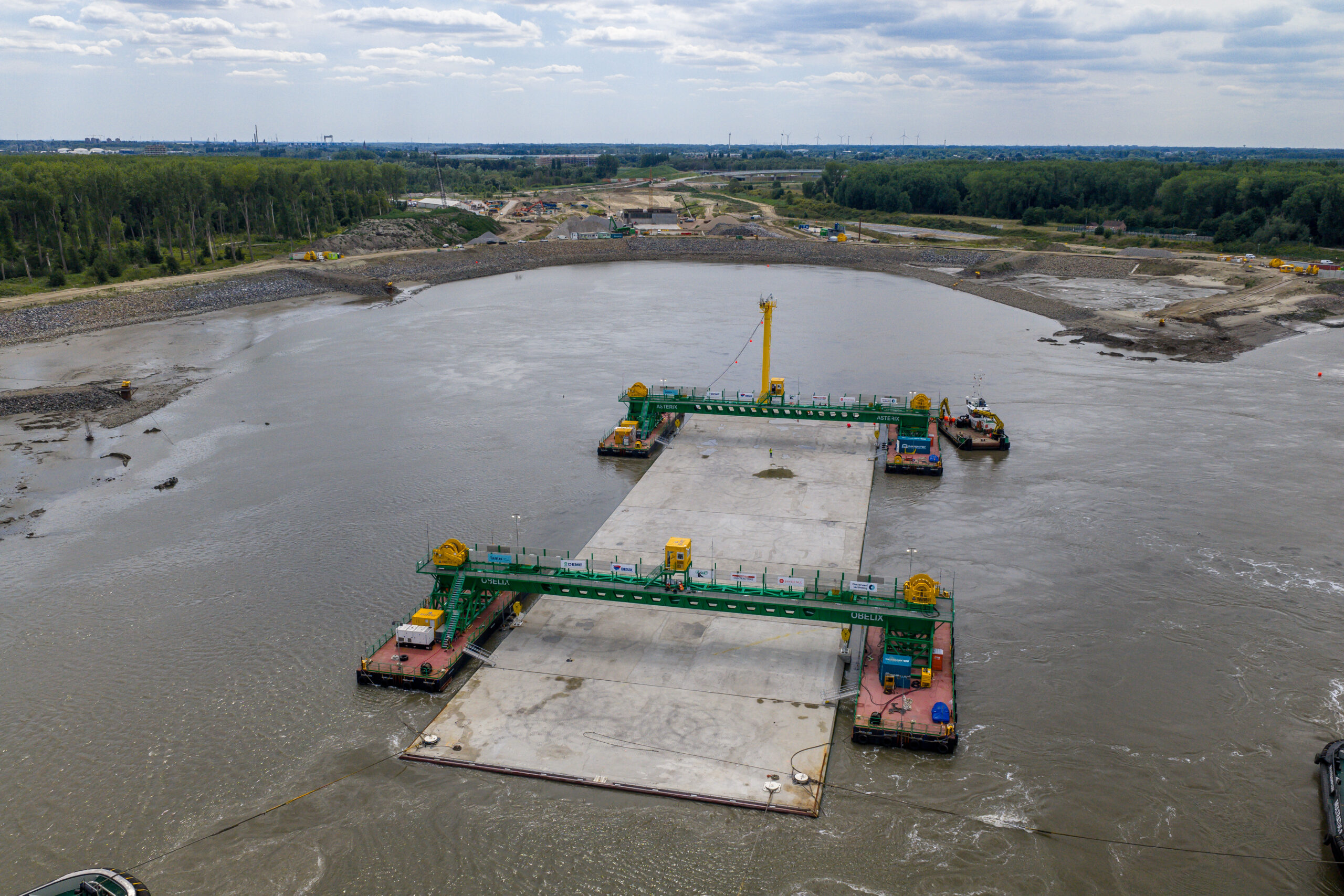 Het eerste element voor de Scheldetunnel wordt in positie gebracht voor het afzinken tegen het landhoofd aan de linkeroever. Foto: Lantis