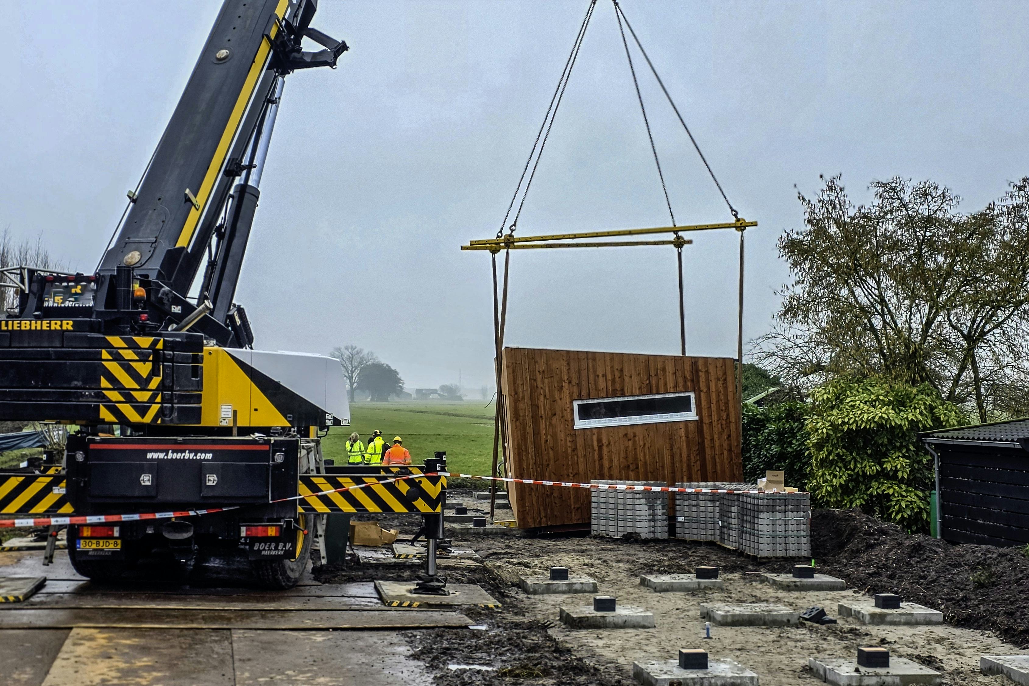 Het slachtoffer kwam tijdens werkzaamheden met een hijskraan onder het tiny house terecht. Hulpdiensten kwamen massaal ter plaatse. Foto ANP