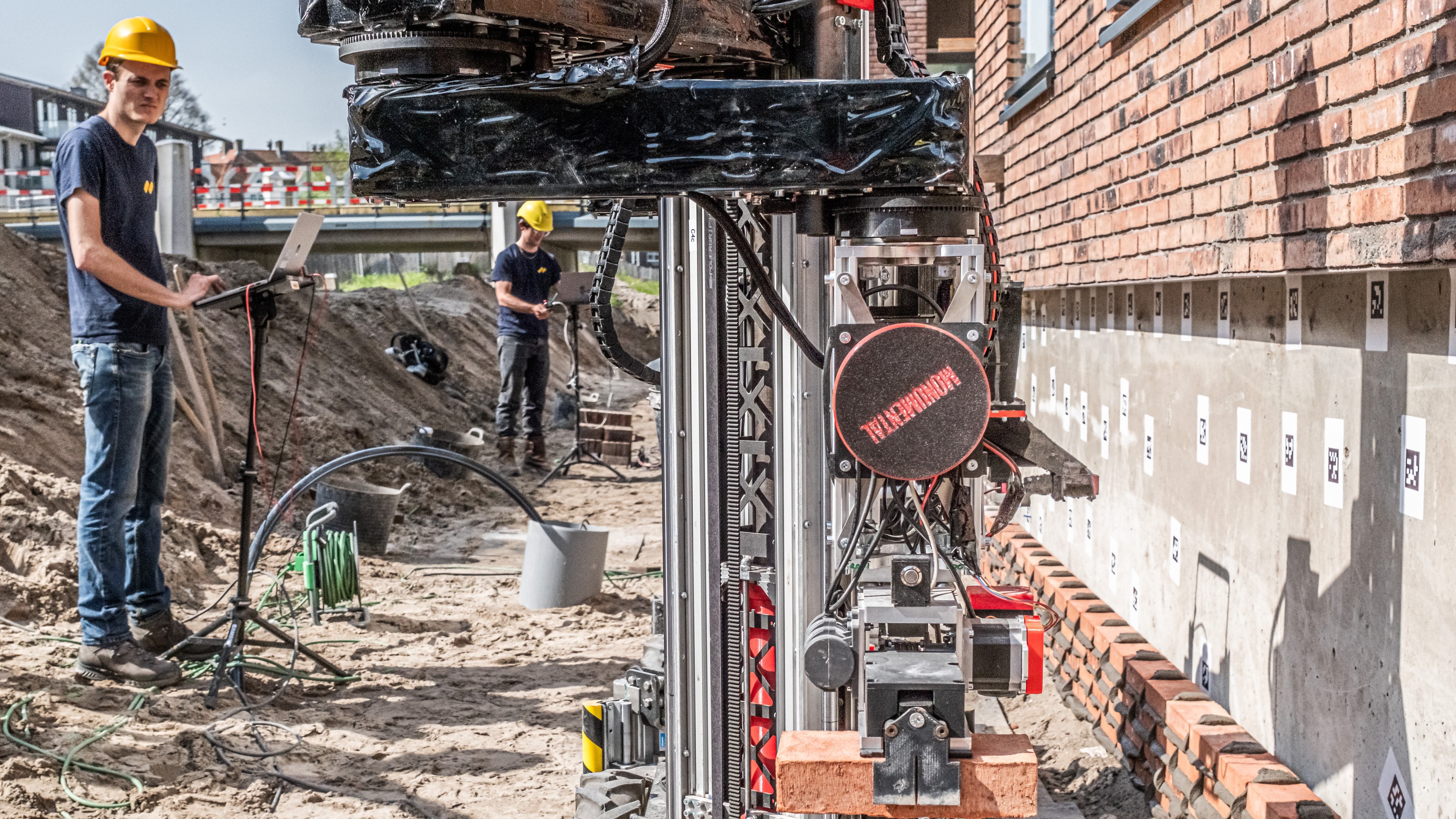 Metselrobots van Monumental aan het werk op een bouwplaats in de Amsterdamse Houthaven. Foto: ANP/Joris van Gennip